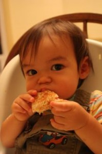 Enjoying his grilled cheese.