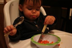 Working hard with his spoon and fork!