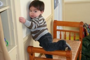 Before we installed the new storage units in the playroom, Noby would climb on the bench and put his legs over the sides.  Only fell twice!!!!