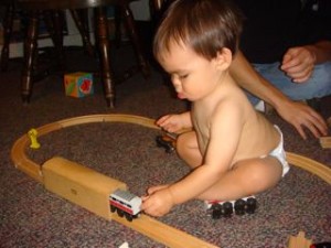 Last but not least, my mom took out Brett G's old Thomas the Train trains and tracks.  Noby loved pushing the train cars through the tunnel.